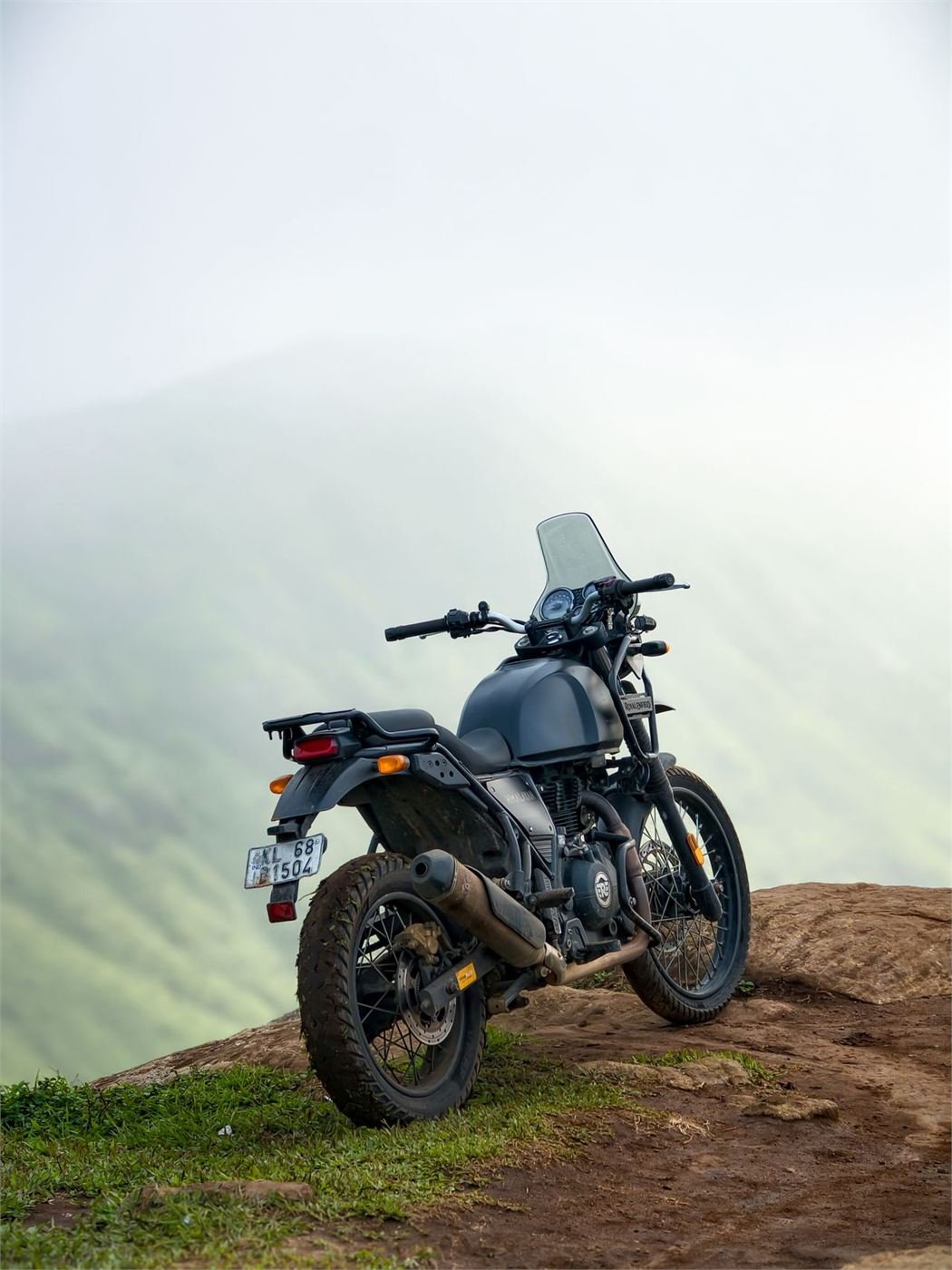 A Royal Enfield Himalayan parked against a cloud-filled sky